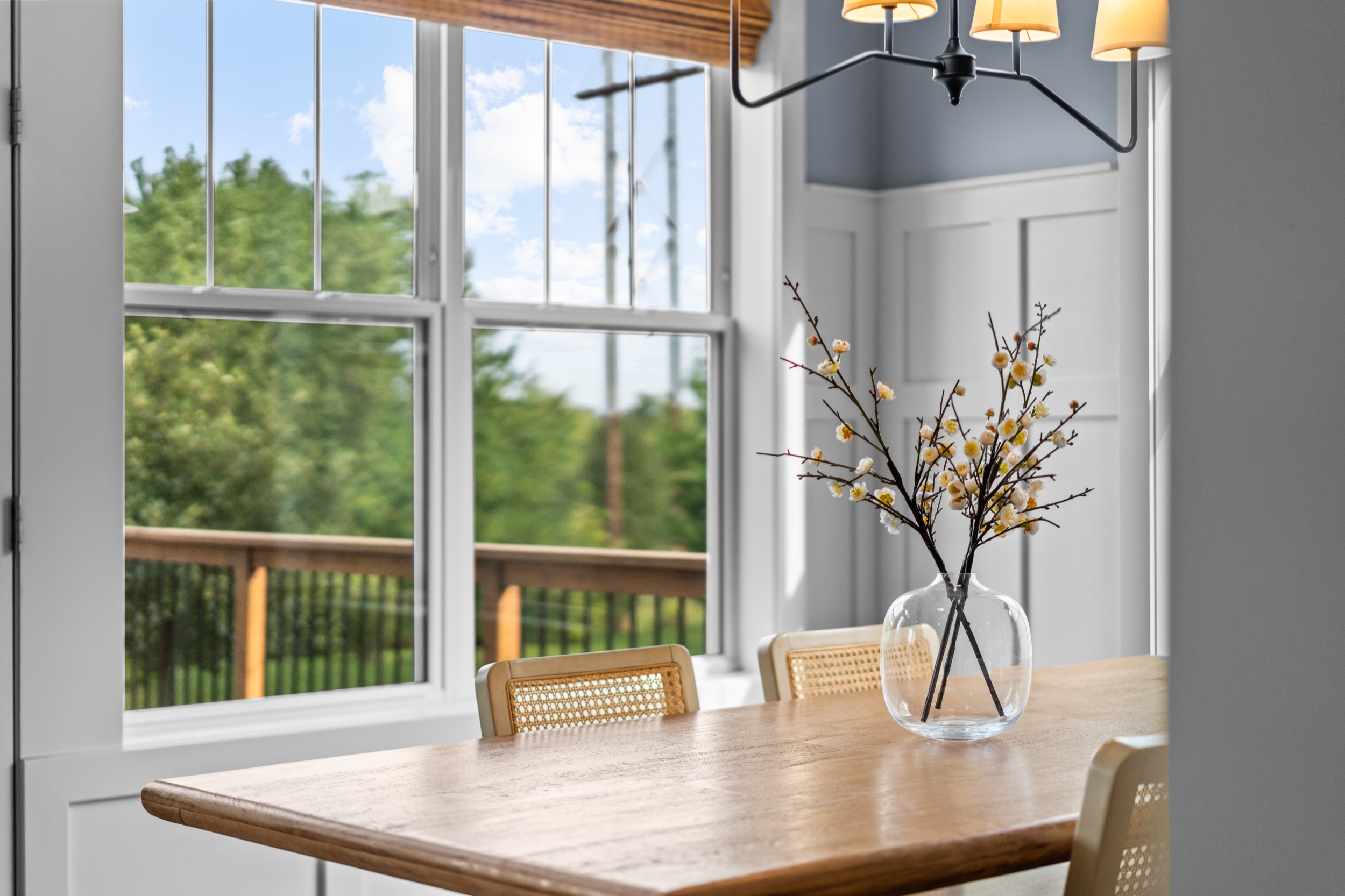 Bright interior view showcasing home layout and window view with decorative floral arrangement.