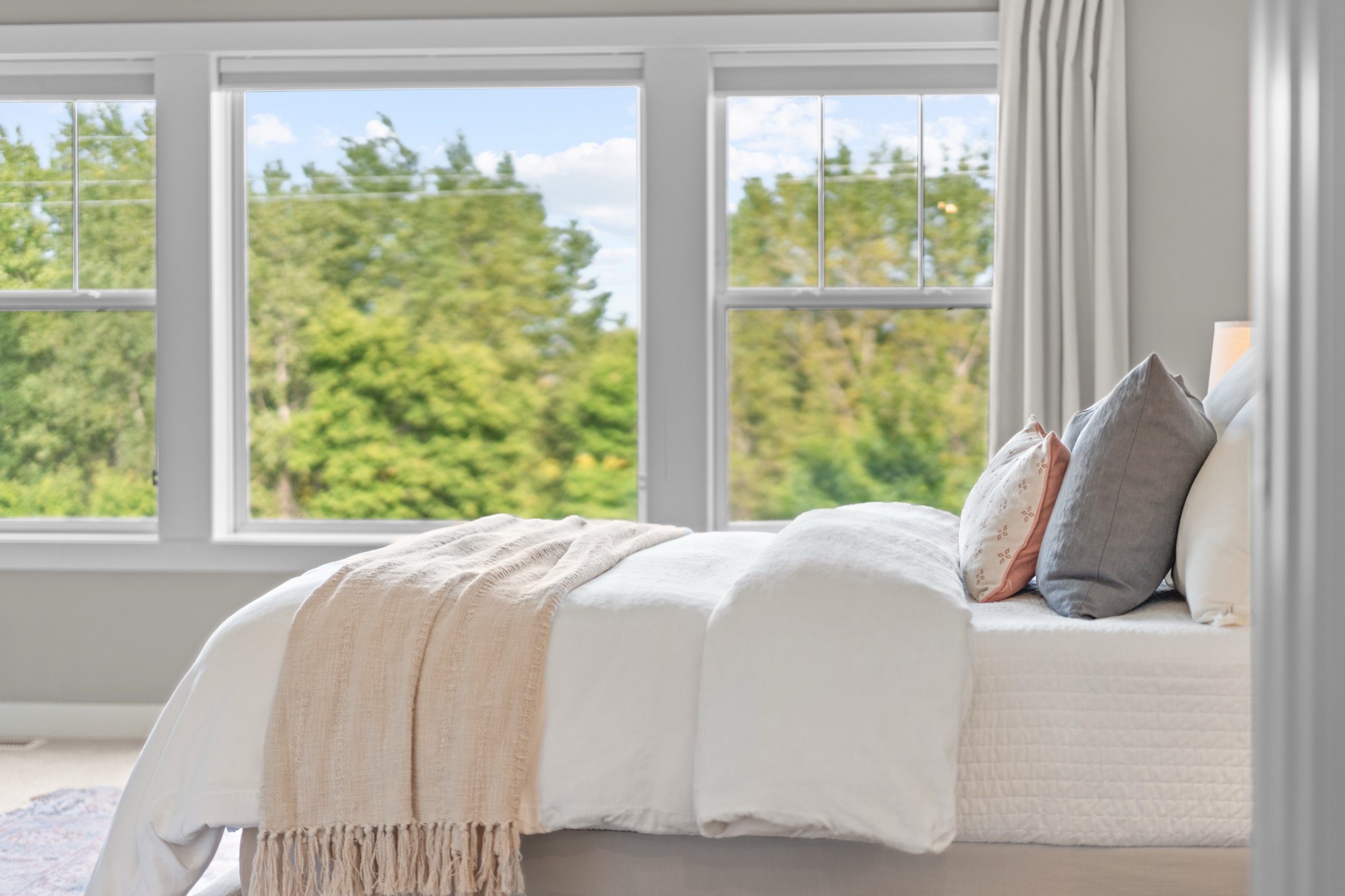 Bright bedroom interior showcasing real estate photography and videography services.