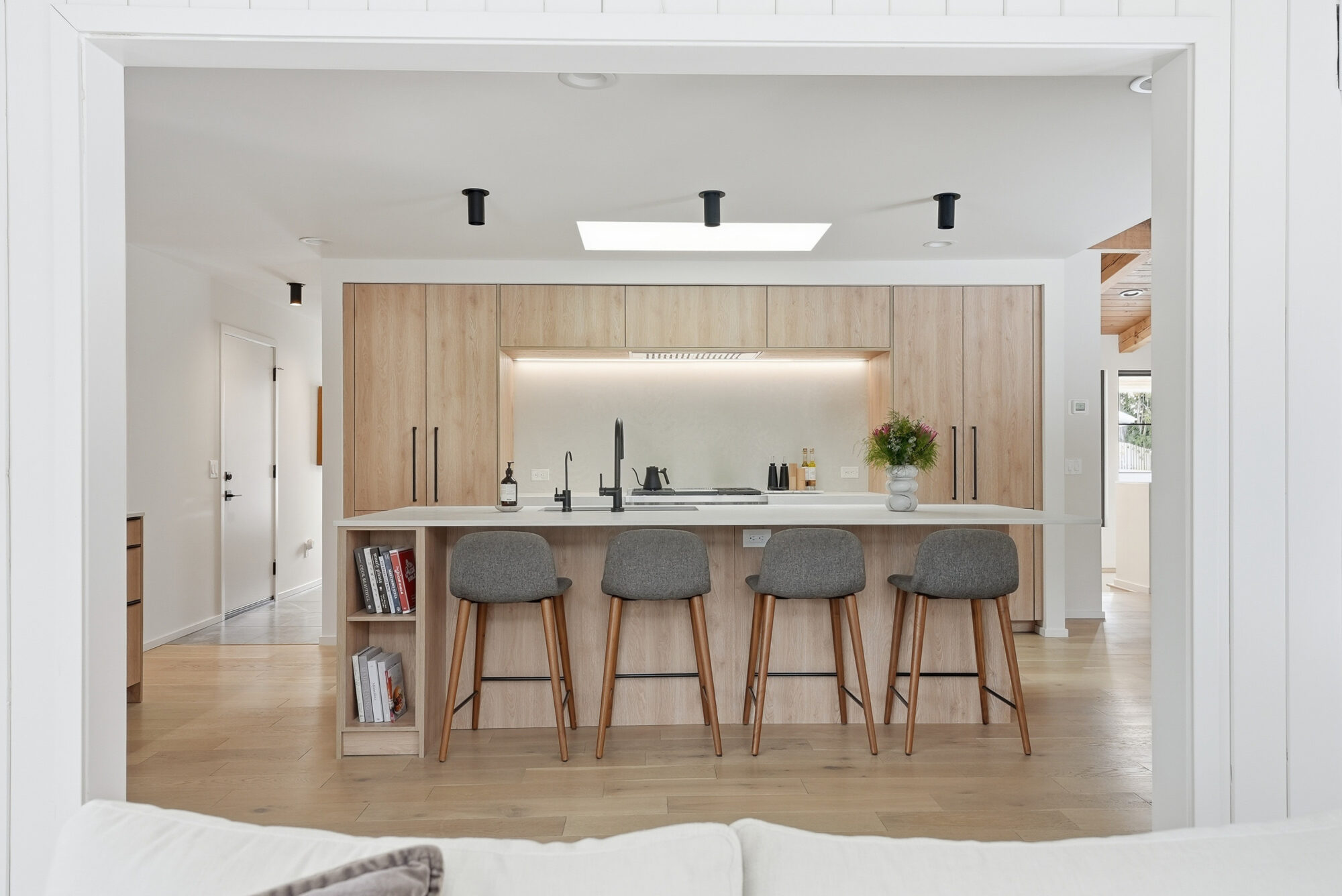 Modern kitchen interior with island and bar stools, showcasing real estate listing video content.