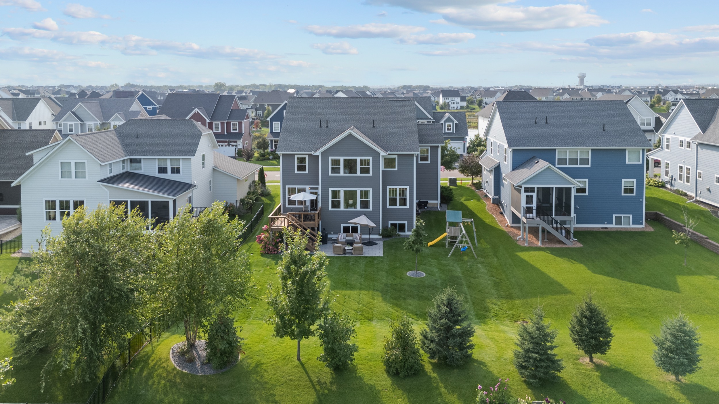 Aerial view of suburban homes and backyards showcasing real estate photography services.