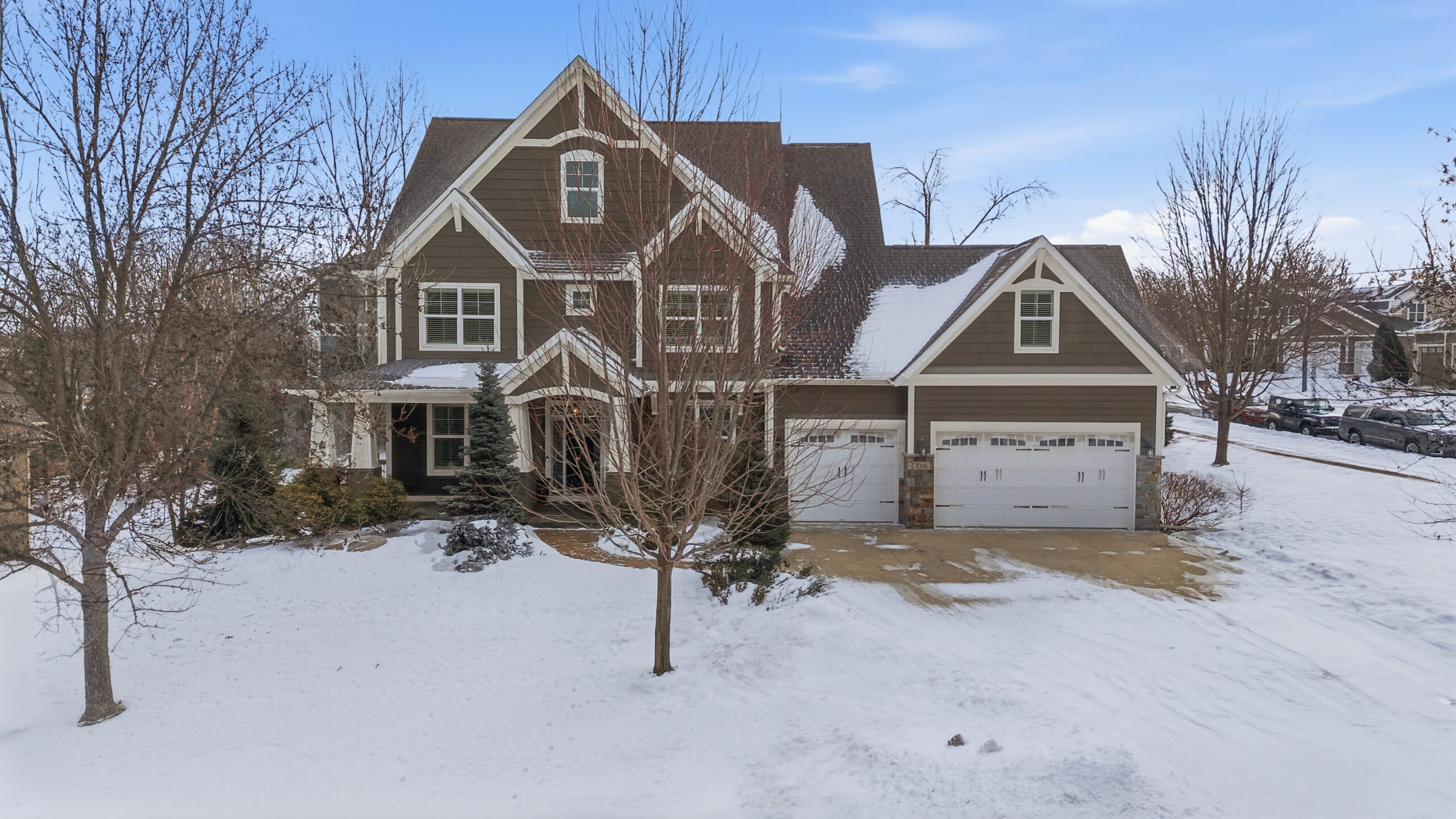 Exterior view of a snow-covered house showcasing real estate photography services.