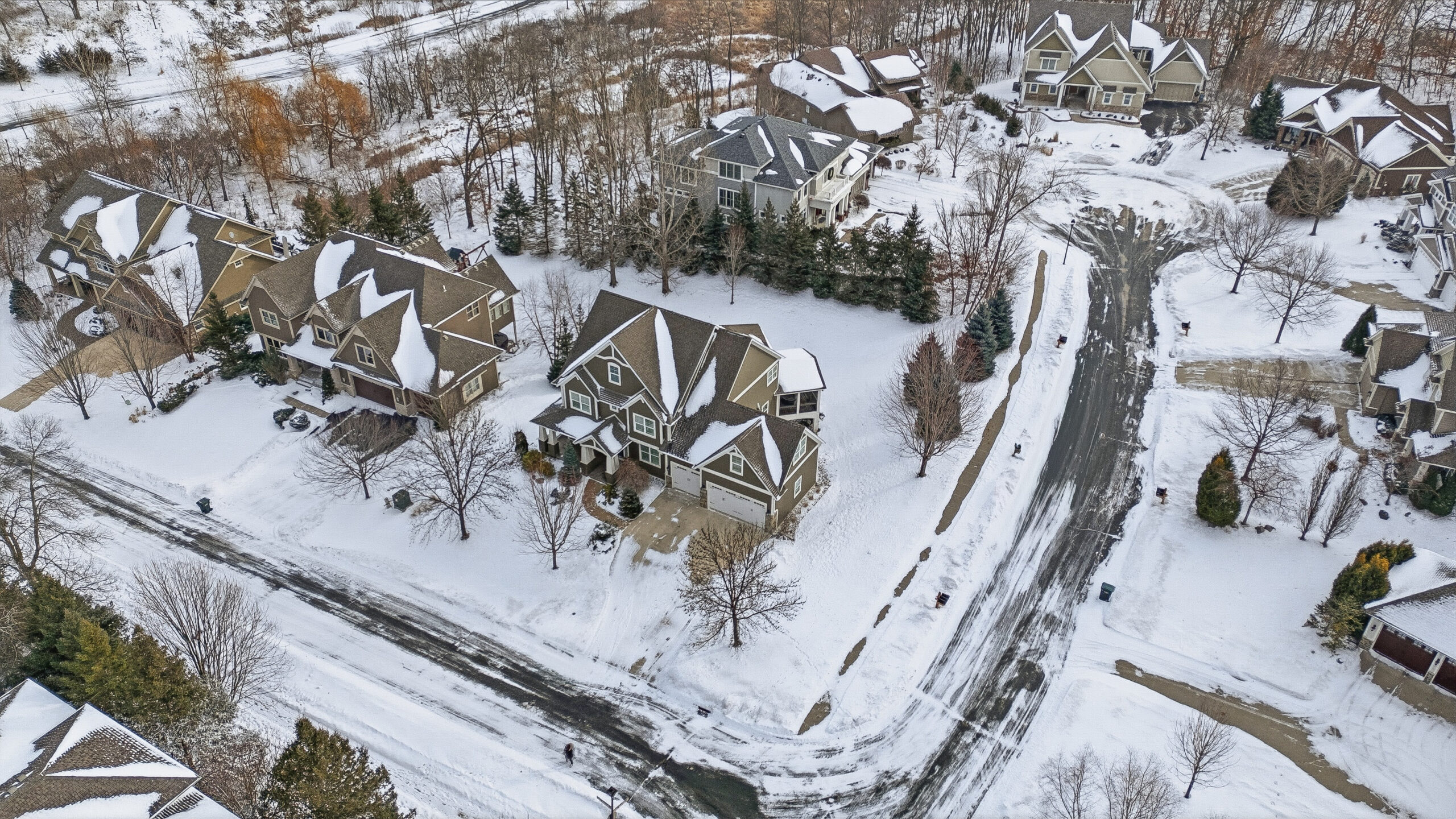 Aerial view of snow-covered homes showcasing real estate photography services.