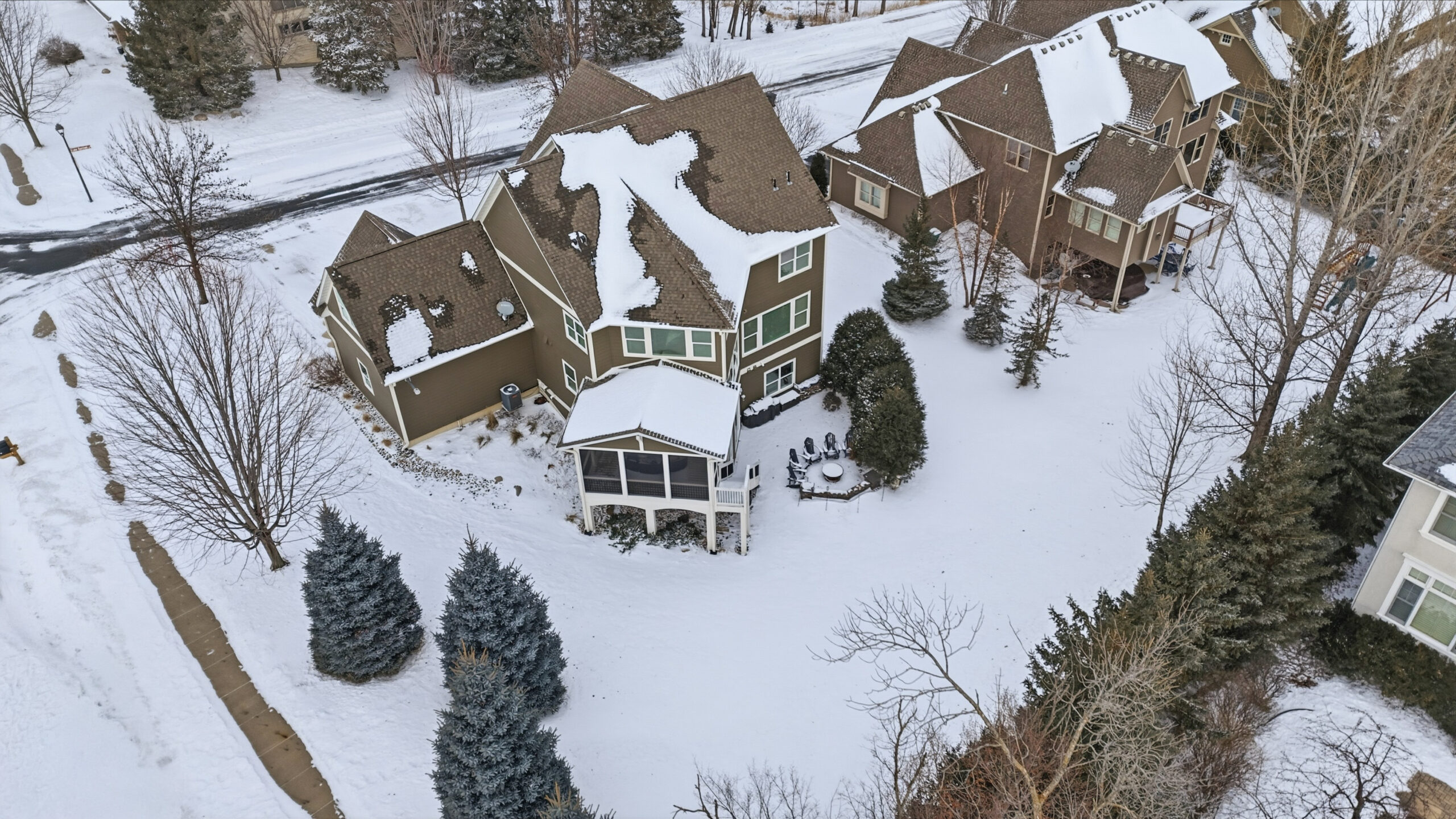 Aerial view of snow-covered homes showcasing real estate photography services.