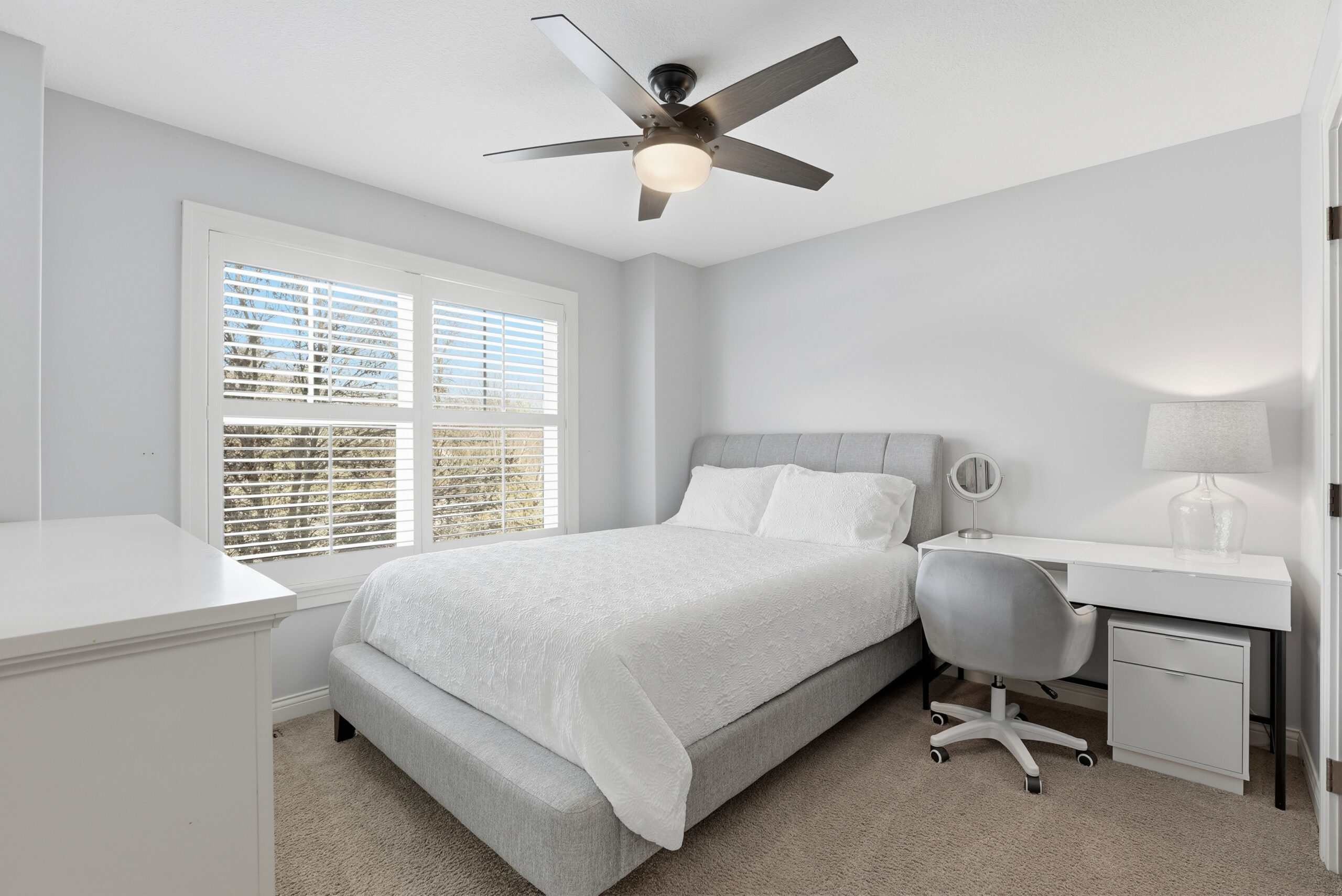 Real estate interior photography of a bedroom with floor plan details and ceiling fan