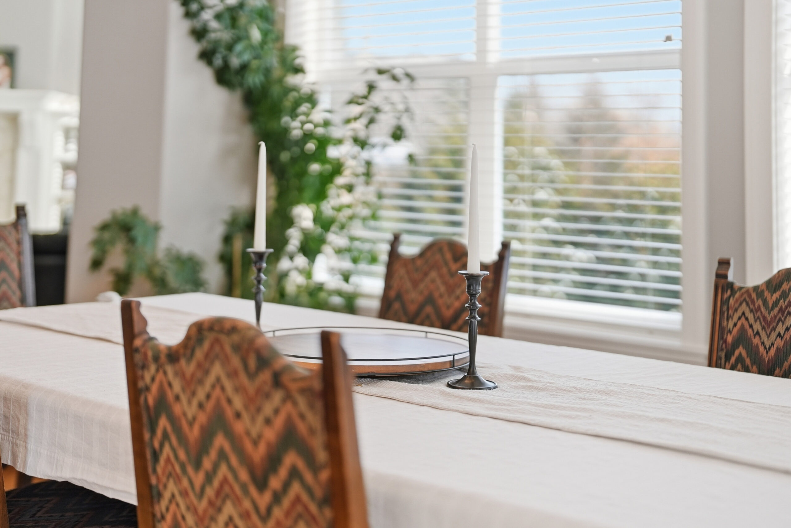 Interior photography showcasing a dining room table and chairs with candles, highlighting real estate photography services.