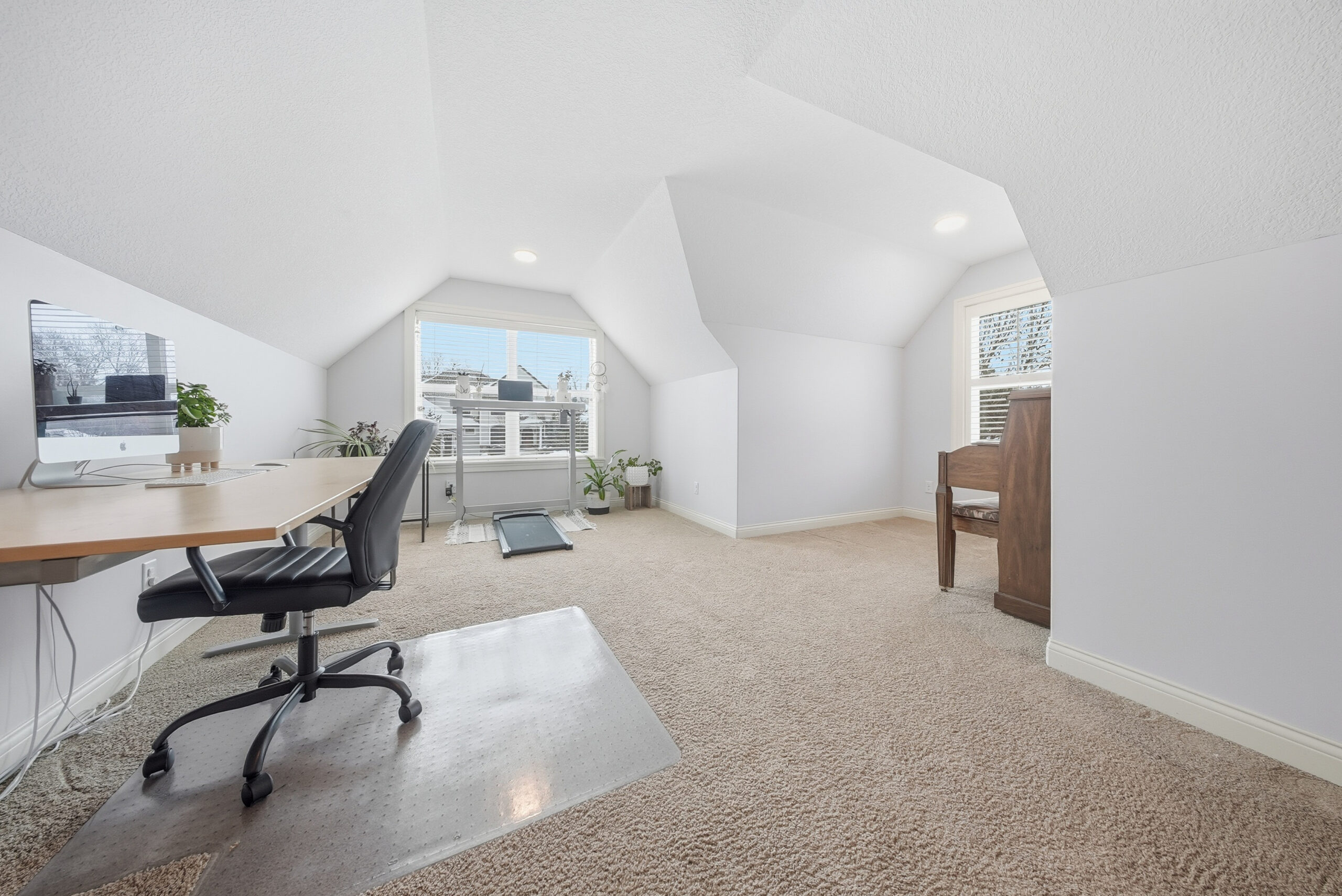 Bright interior space with window and desk, showcasing real estate photography by Corridor Media.
