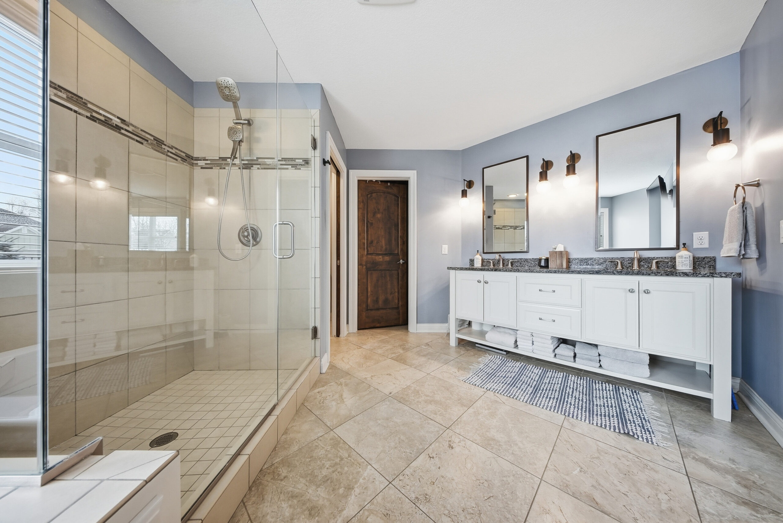 Real estate photography showcasing a modern bathroom with glass shower and vanity.