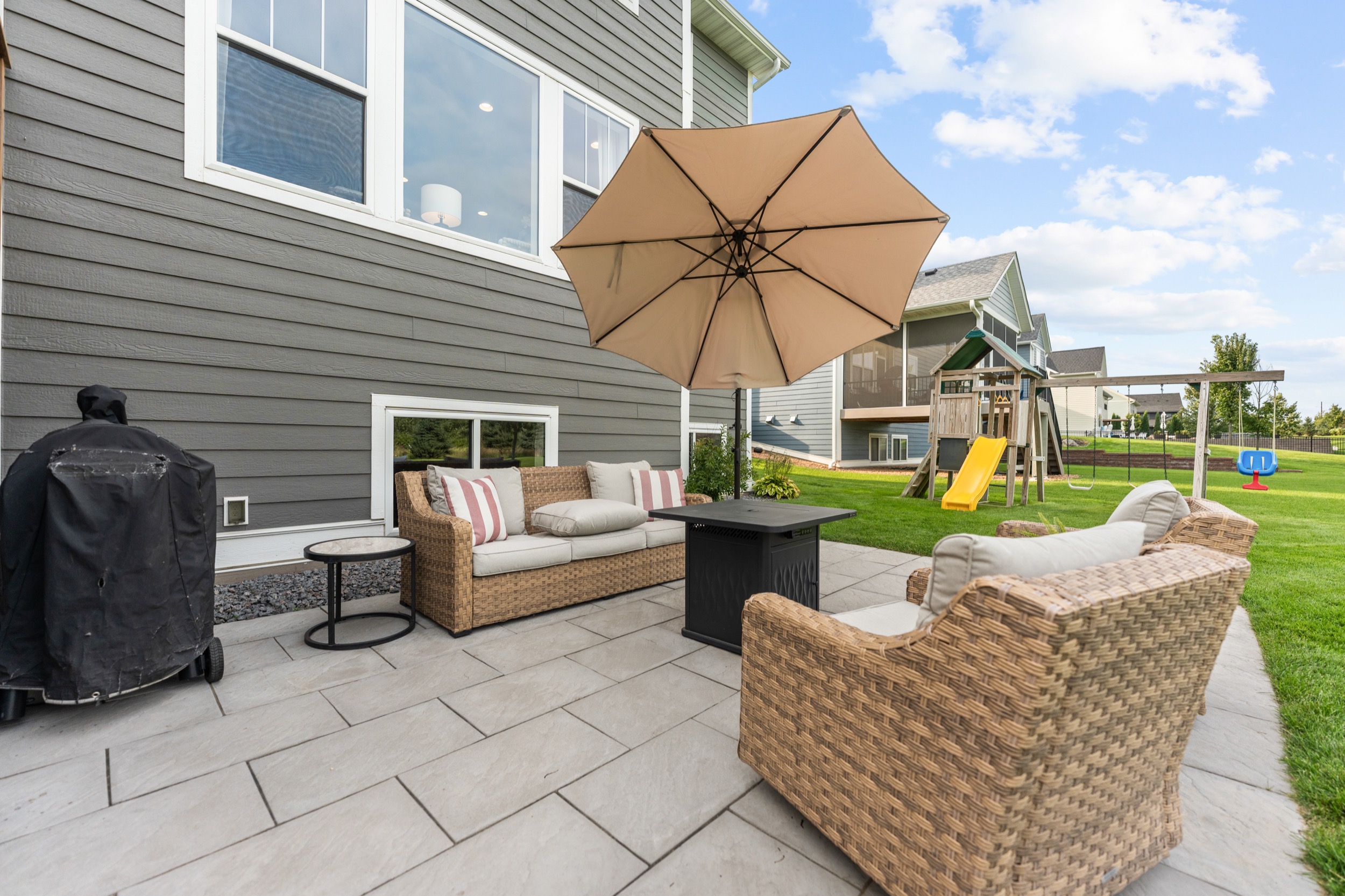 Exterior patio with furniture and backyard, real estate photography by Corridor Media.