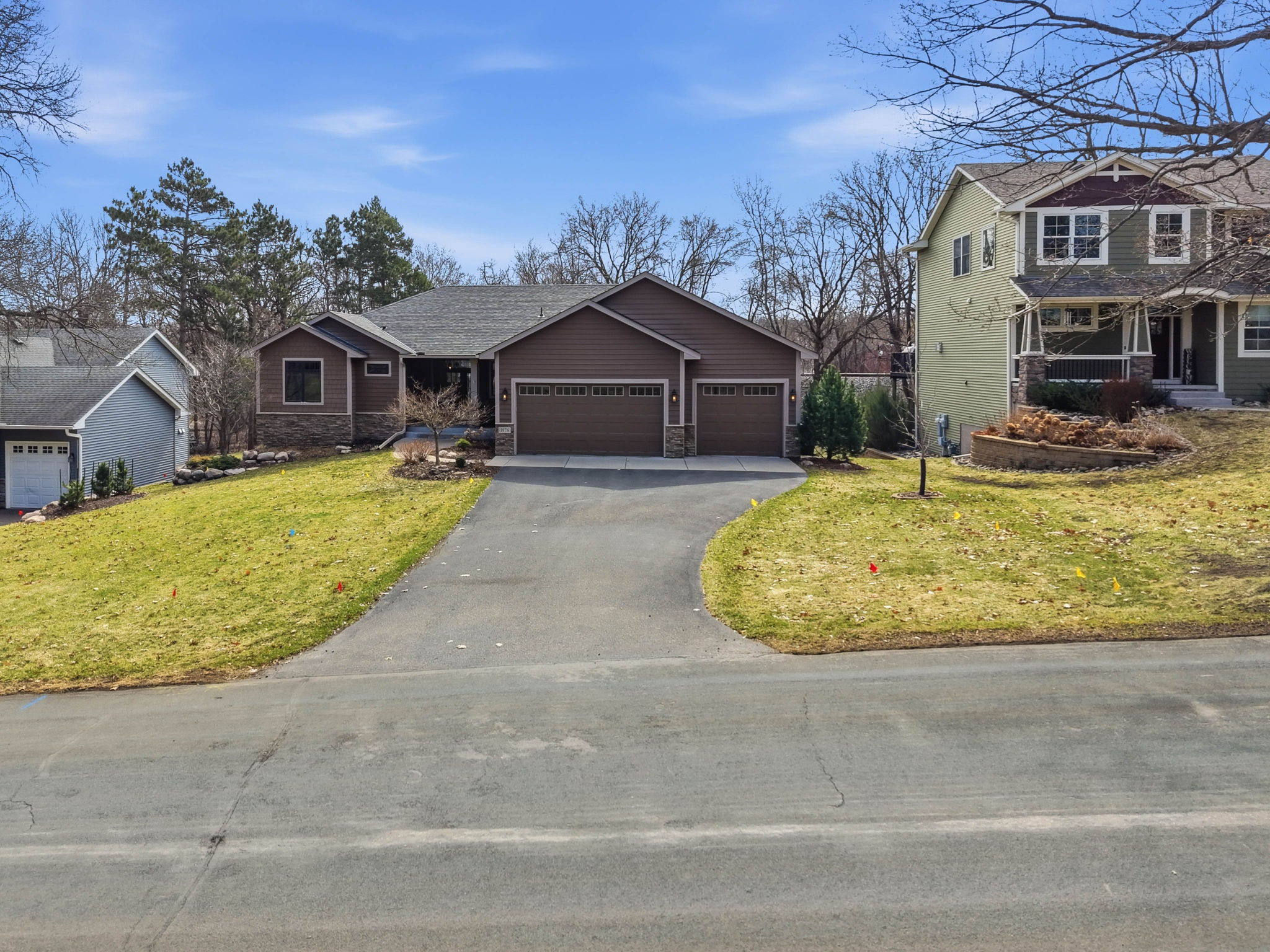 Walkout rambler home on Thom Drive in Arden Hills, MN, featuring a three-car garage and landscaped yard.