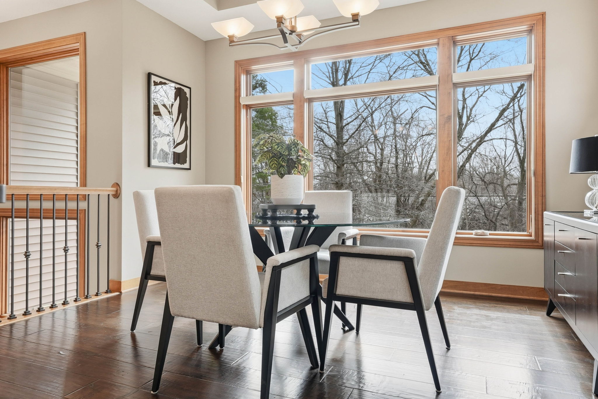 Bright dining area with large windows and modern furniture in Arden Hills home.
