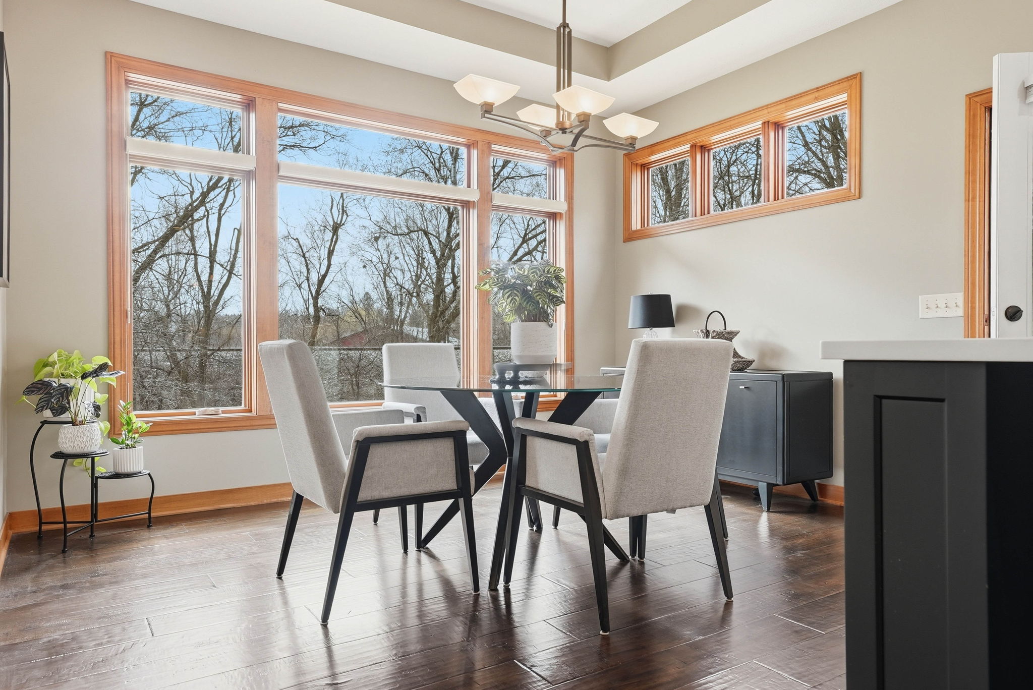 Modern dining area with large windows and hardwood floors in Arden Hills home.