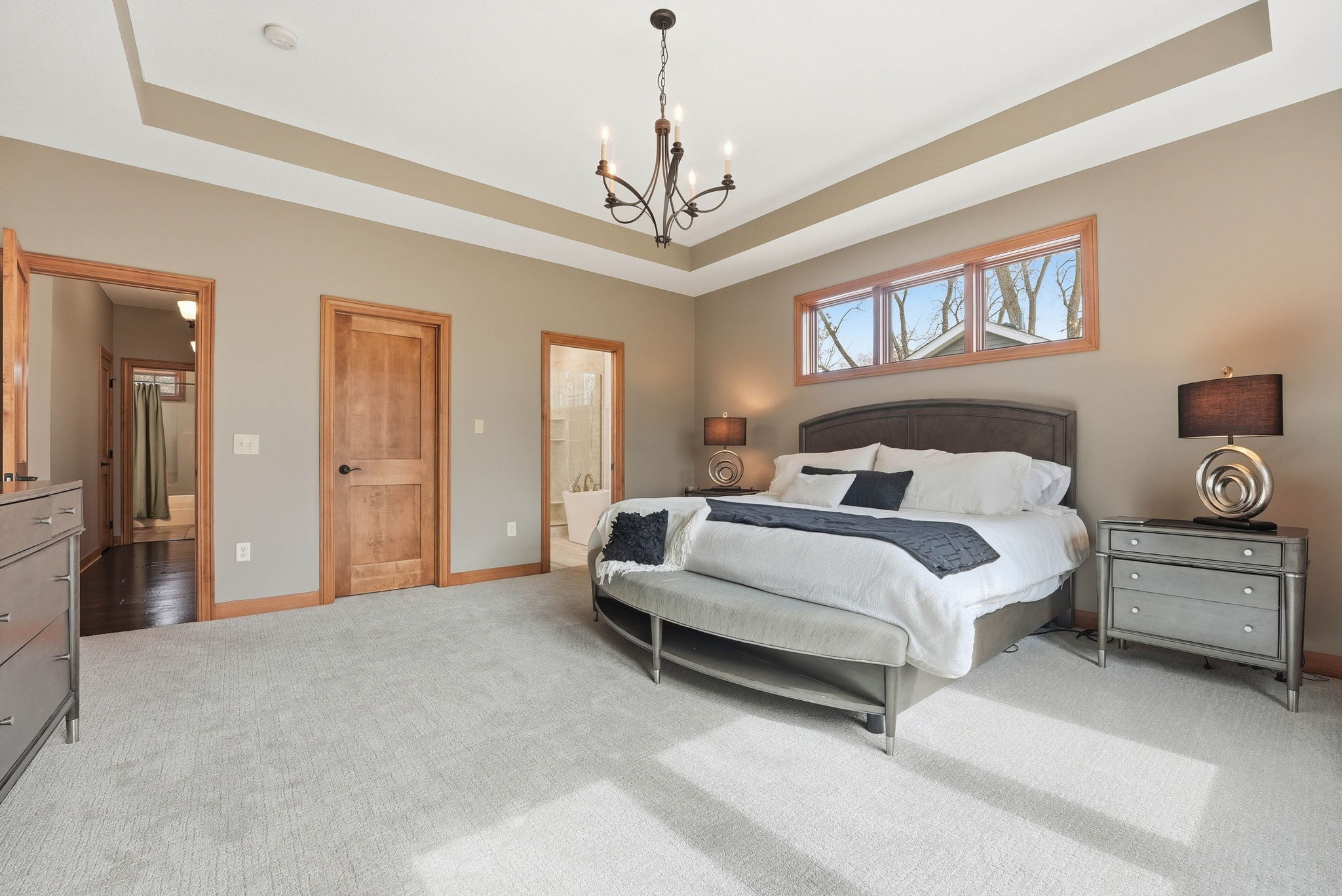 Updated Arden Hills walkout rambler bedroom with hardwood floors and large window.