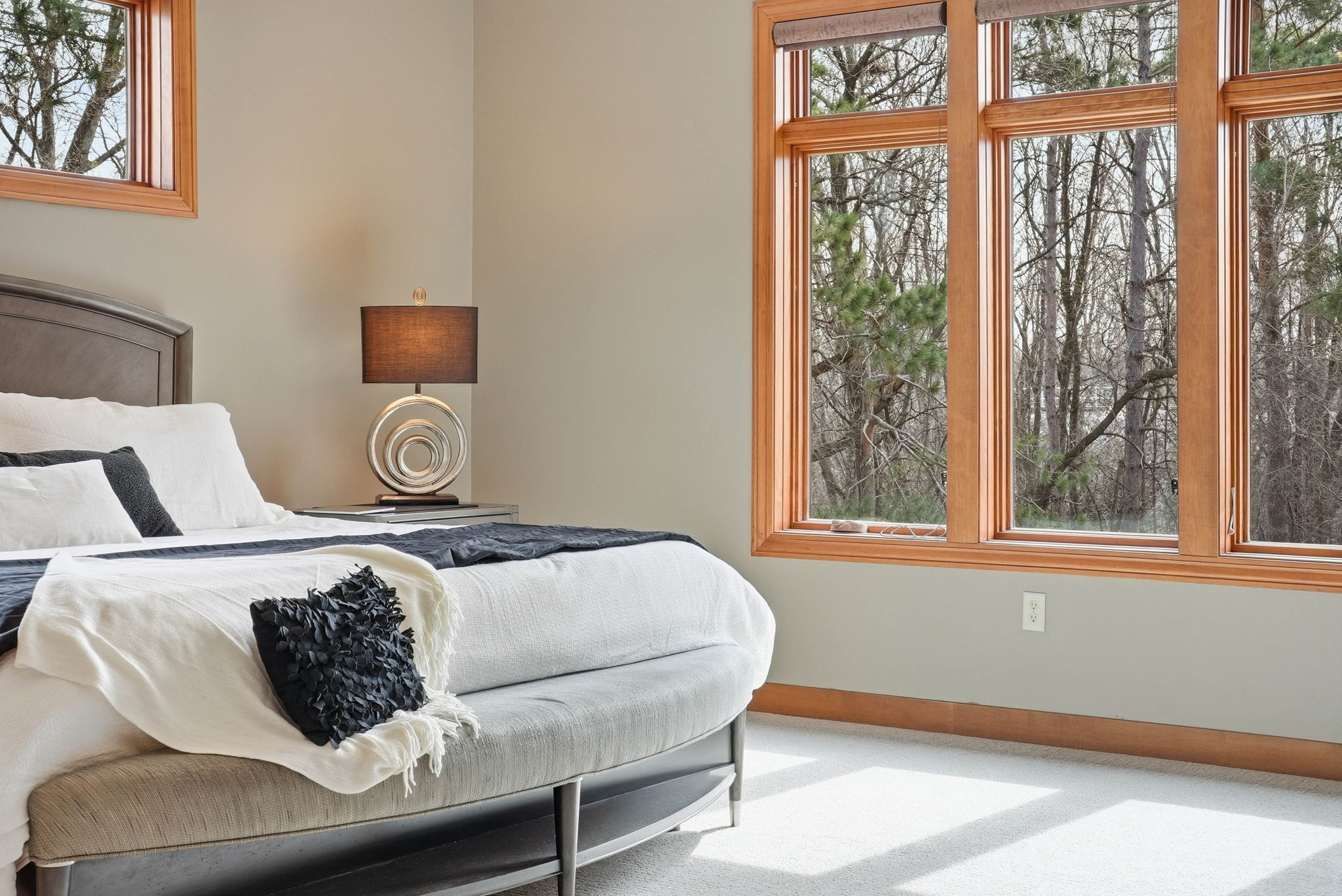 Walkout rambler bedroom with large windows and updated finishes.