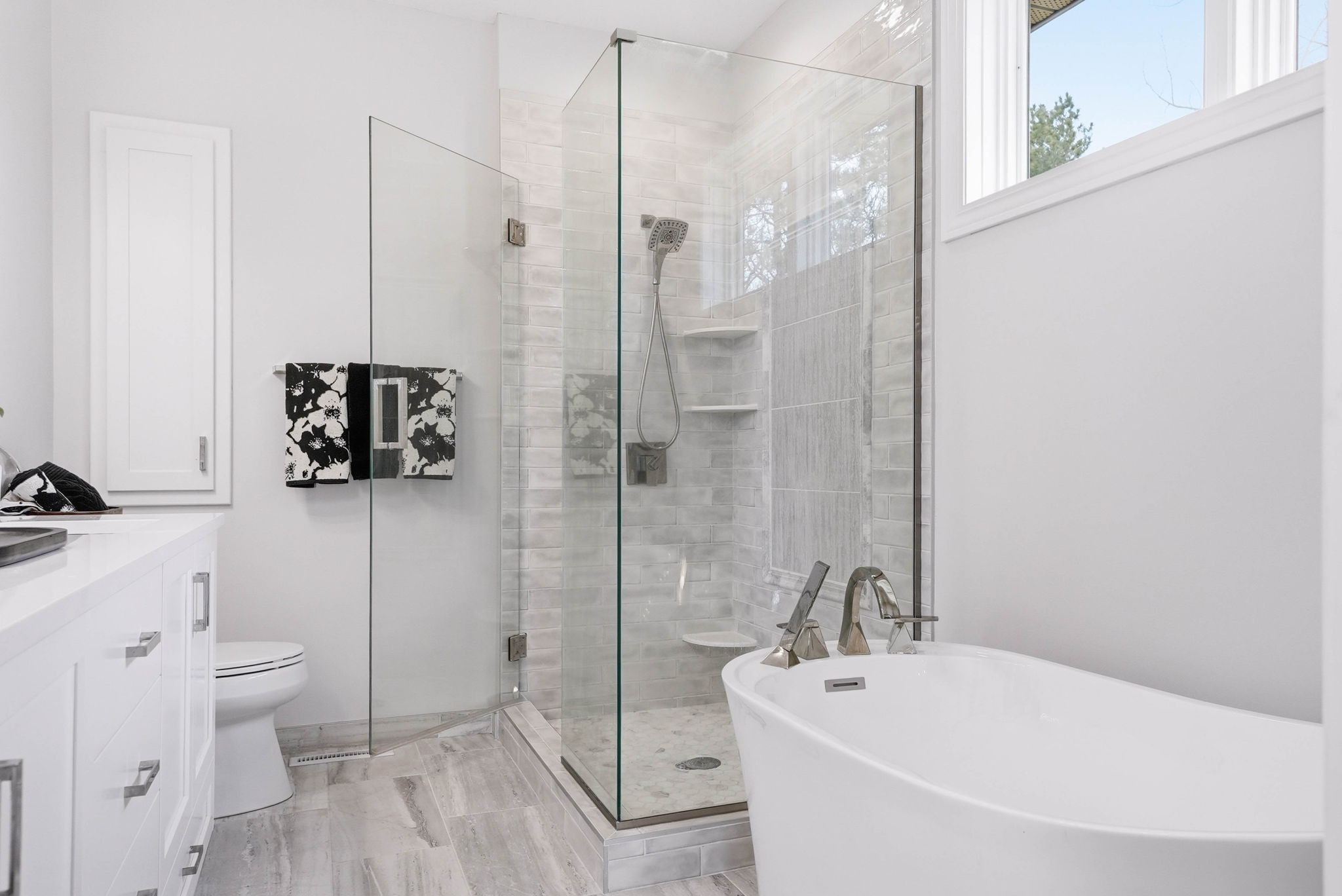 Remodeled bathroom with glass shower enclosure and walkout rambler features.