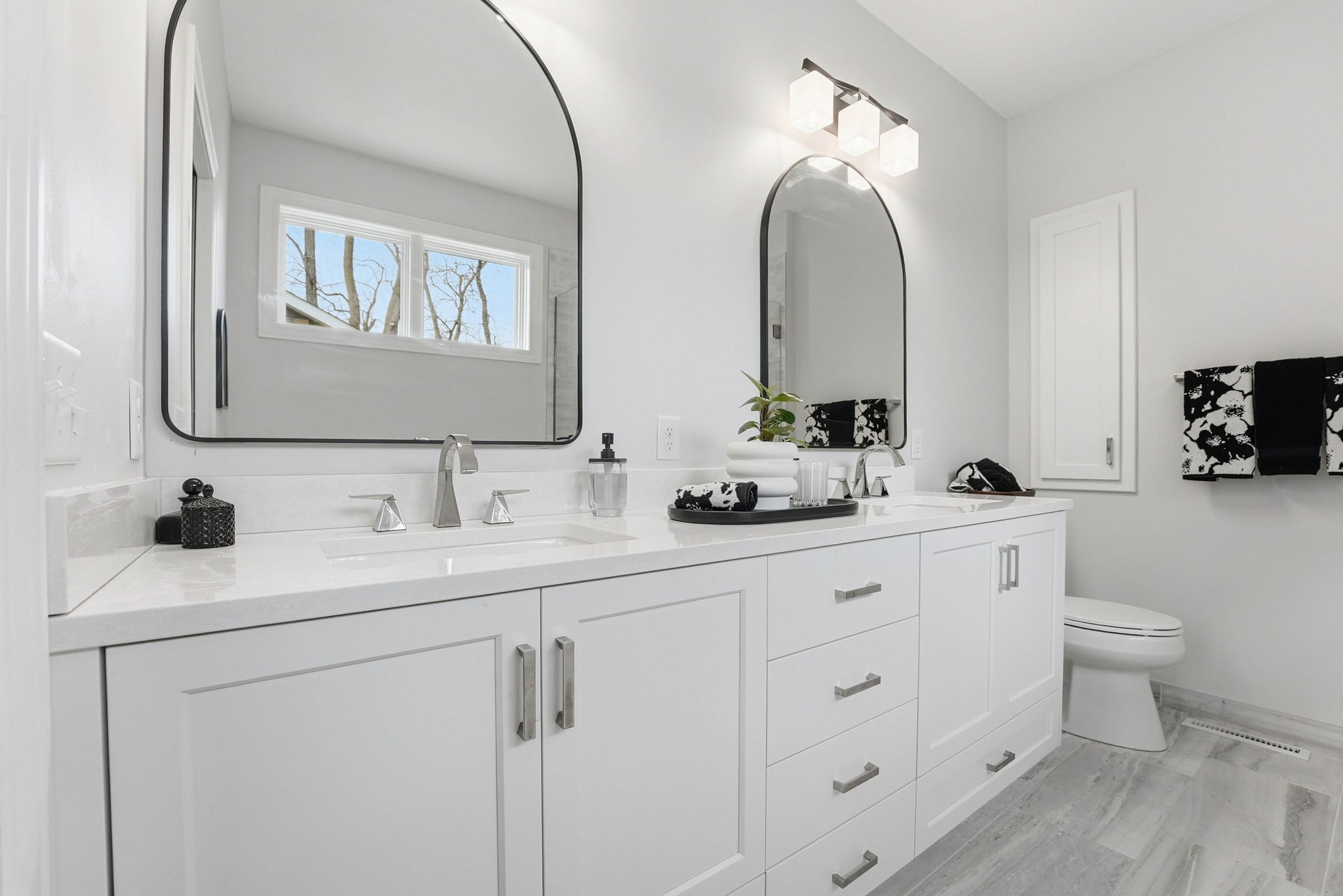 Remodeled bathroom interior with double vanity and large mirror in Arden Hills home.
