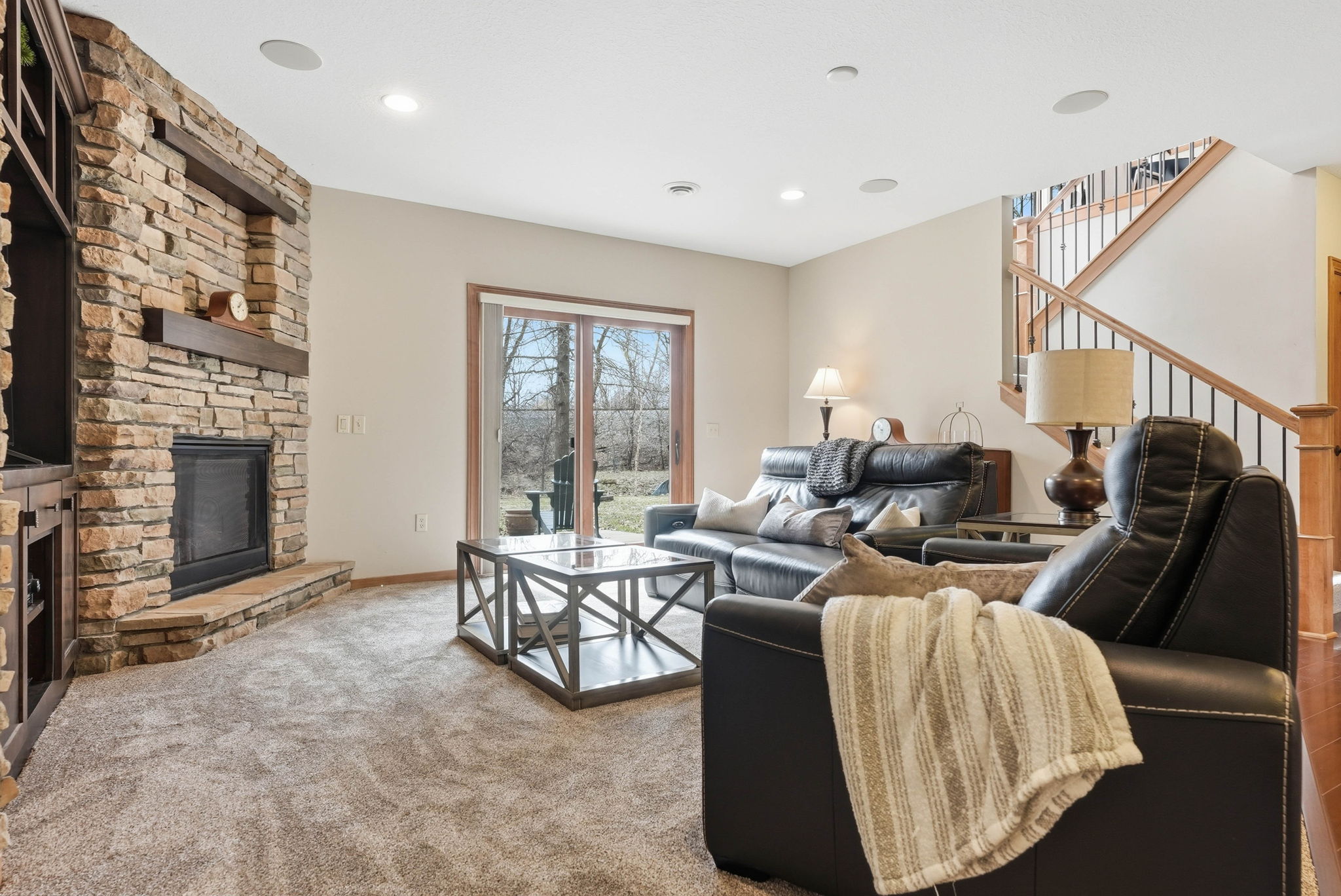 Walkout rambler living room with stone fireplace and updated interior details.