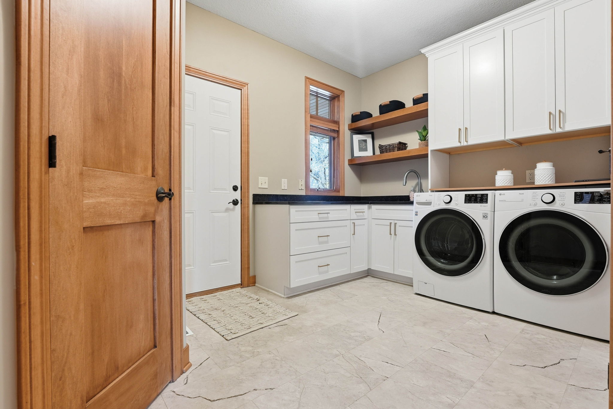 Updated mudroom and laundry area with quartz countertops and built-in storage, Arden Hills home.