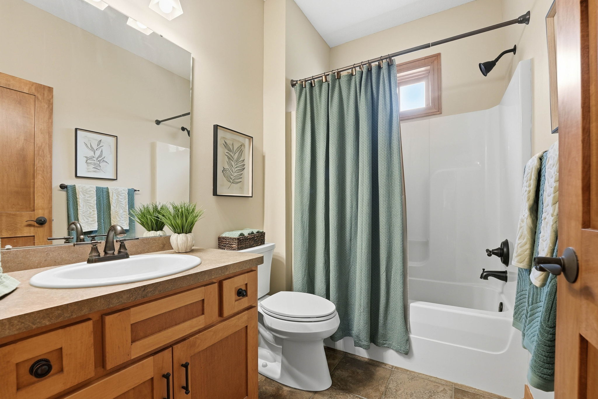 Remodeled primary bathroom with double vanity, quartz countertops, and separate tub and shower in Arden Hills home.