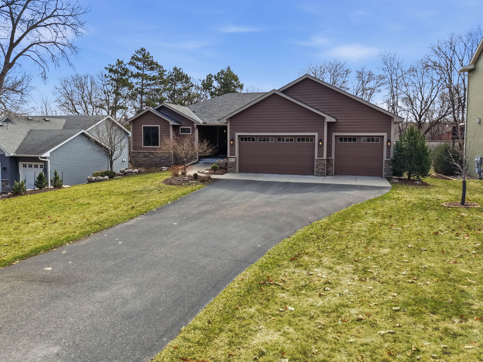 Walkout rambler home in Arden Hills, MN, with three-car garage and landscaped yard.