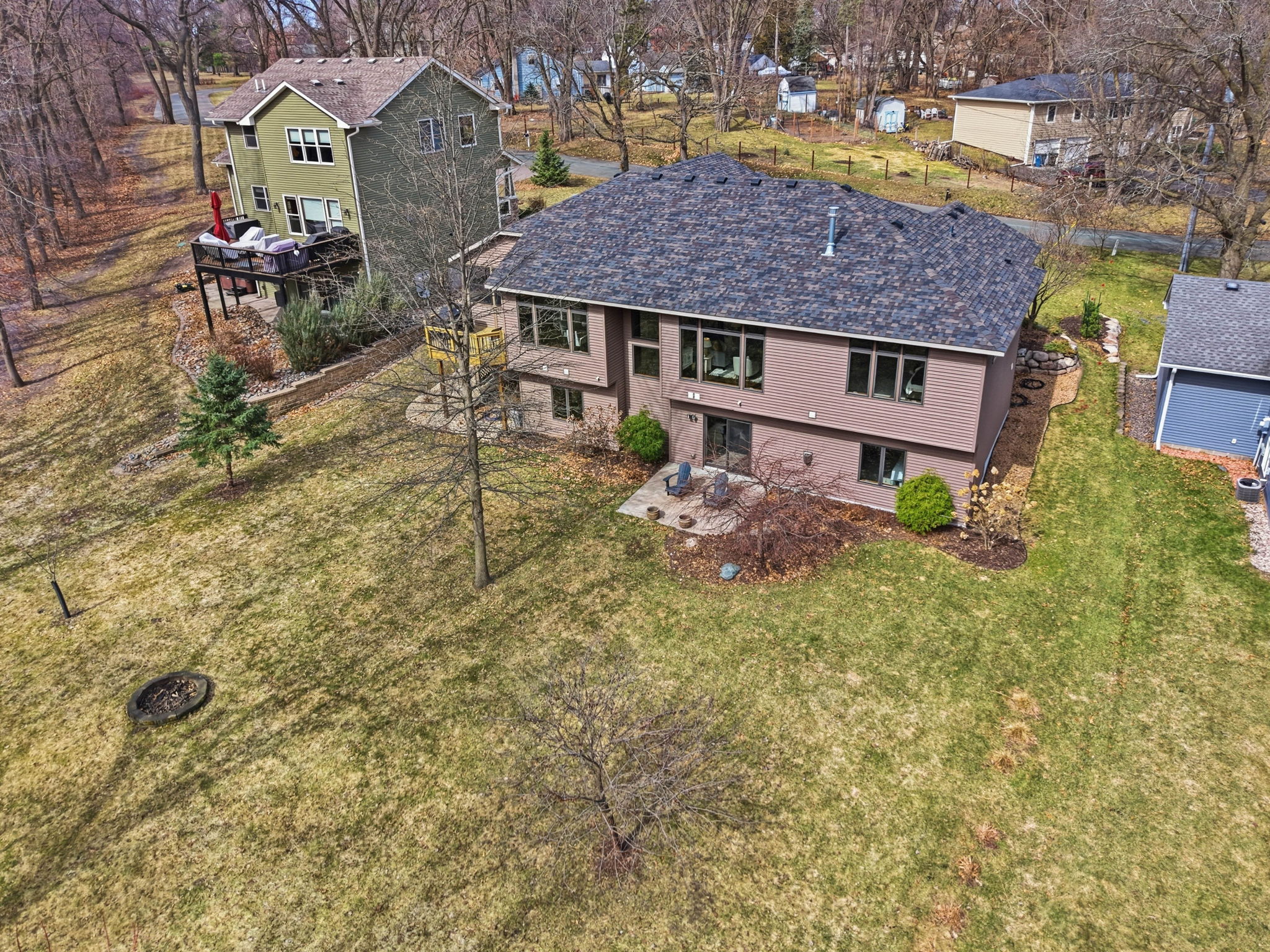 Aerial view of walkout rambler home in Arden Hills, MN and expansive backyard with deck